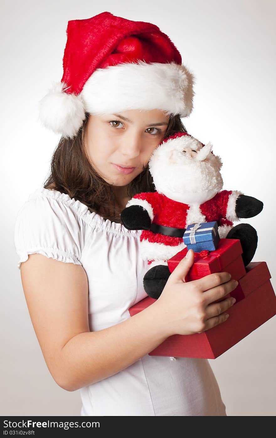 Teenager with santa red hat and gifts for christmas. Teenager with santa red hat and gifts for christmas