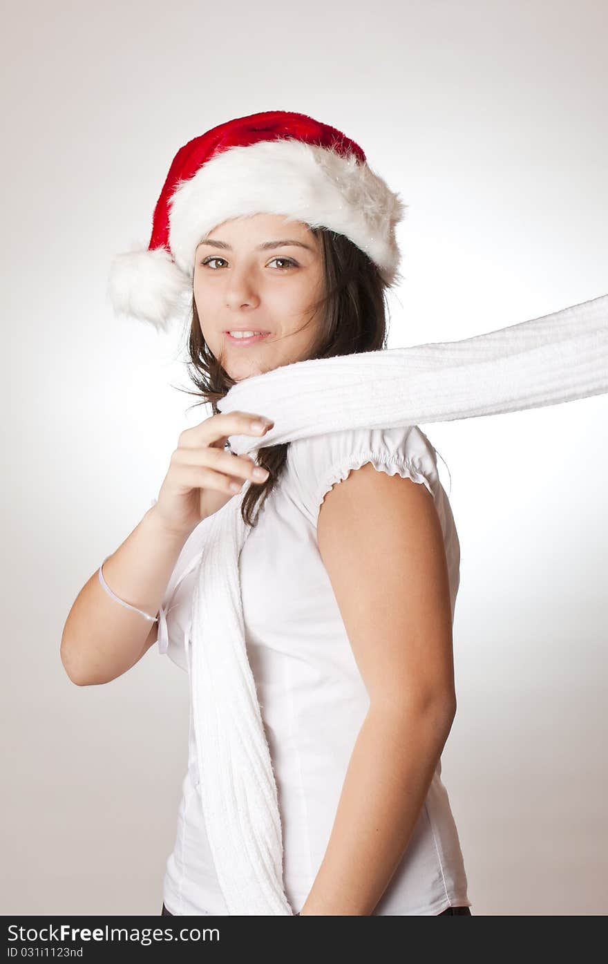 Young girl with red santa hat and white scarf. Young girl with red santa hat and white scarf