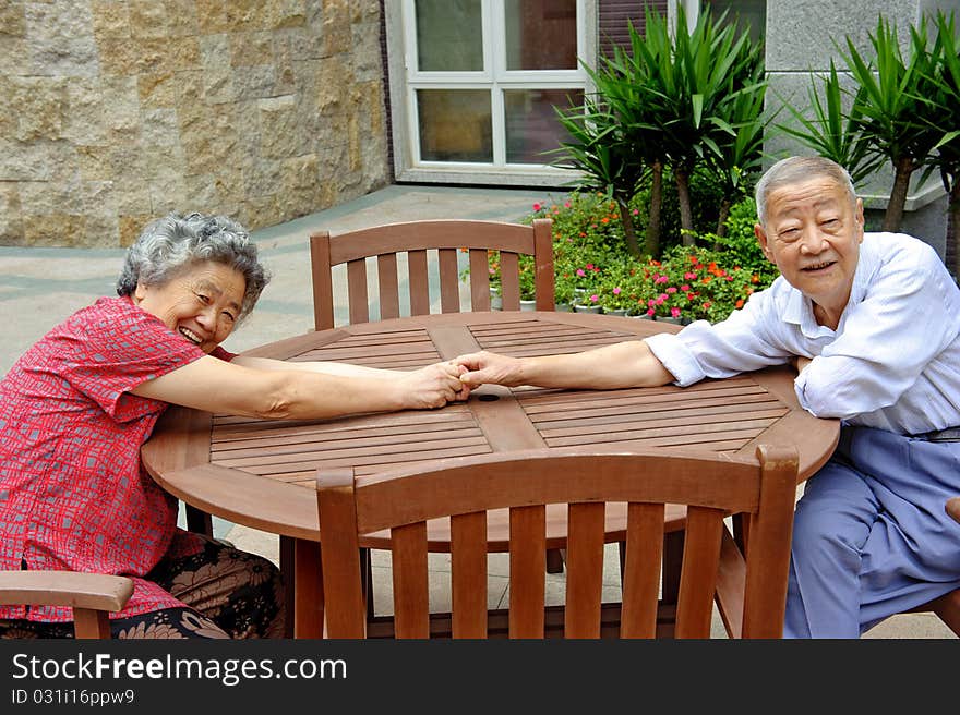 An intimate senior couple in a park. An intimate senior couple in a park