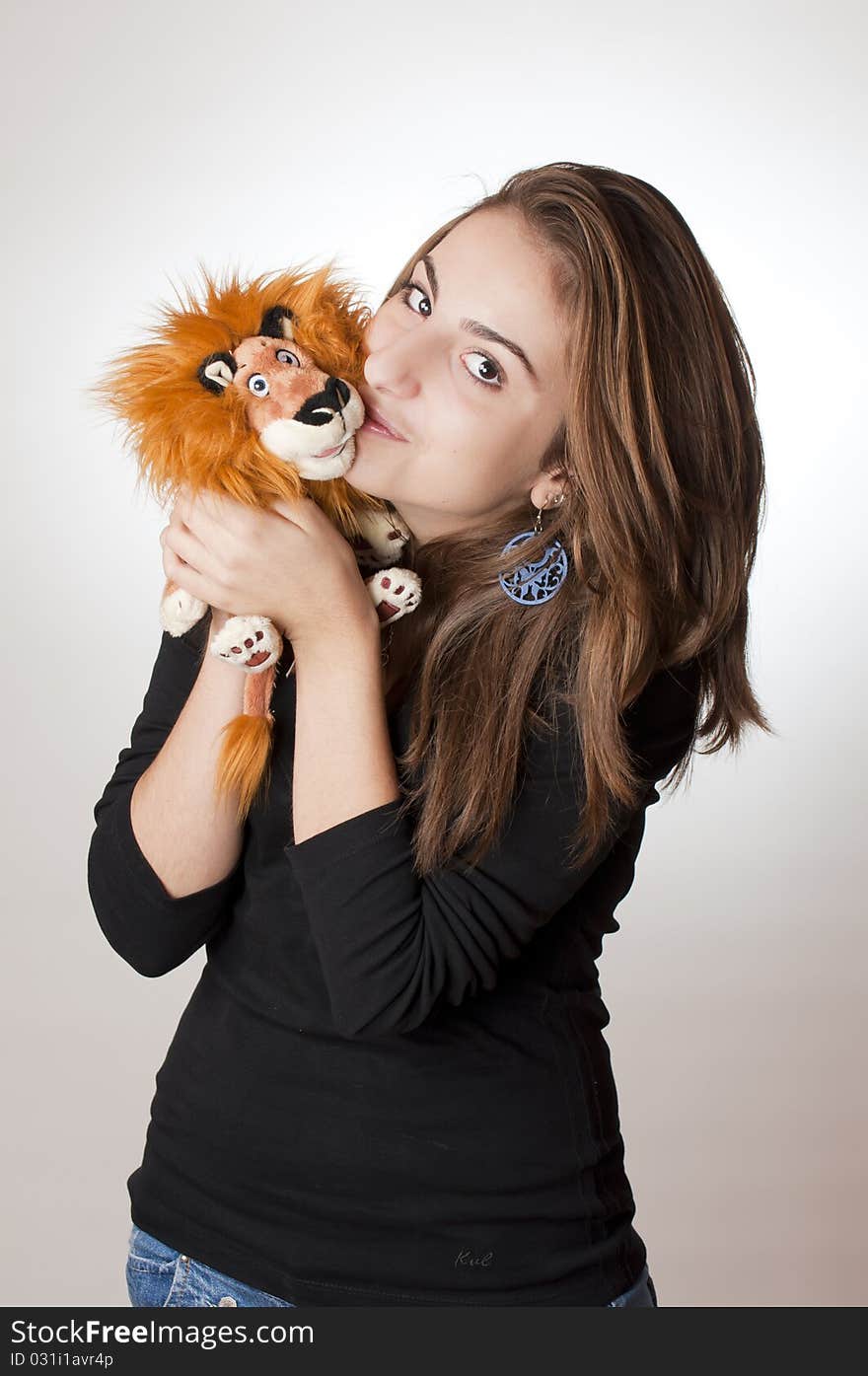 Young girl with her lion toy