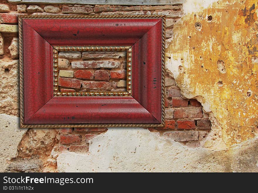 Empty picture frame on an old weathered brick wall with stucco.