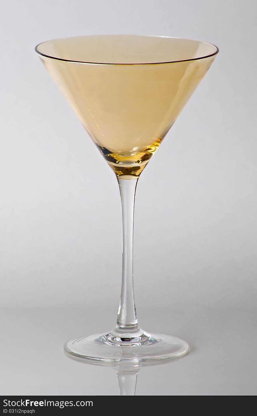 Yellow top martini glass on white background.