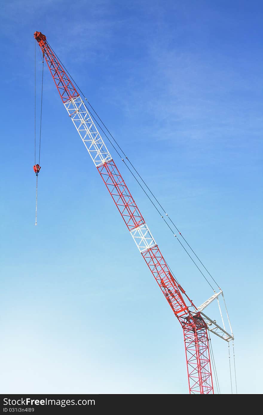 Red & Blue hoisting crane isolate with sky. Red & Blue hoisting crane isolate with sky