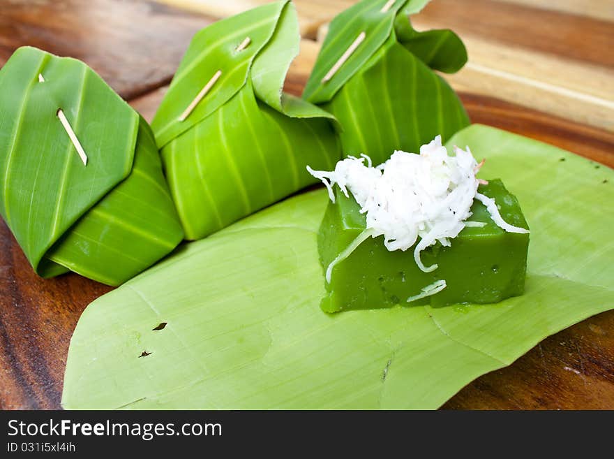 Green sweet pudding call Kanom Peakpoon made of Pandanus leaf flavor and coconut and banana leaf as it's packages. Green sweet pudding call Kanom Peakpoon made of Pandanus leaf flavor and coconut and banana leaf as it's packages