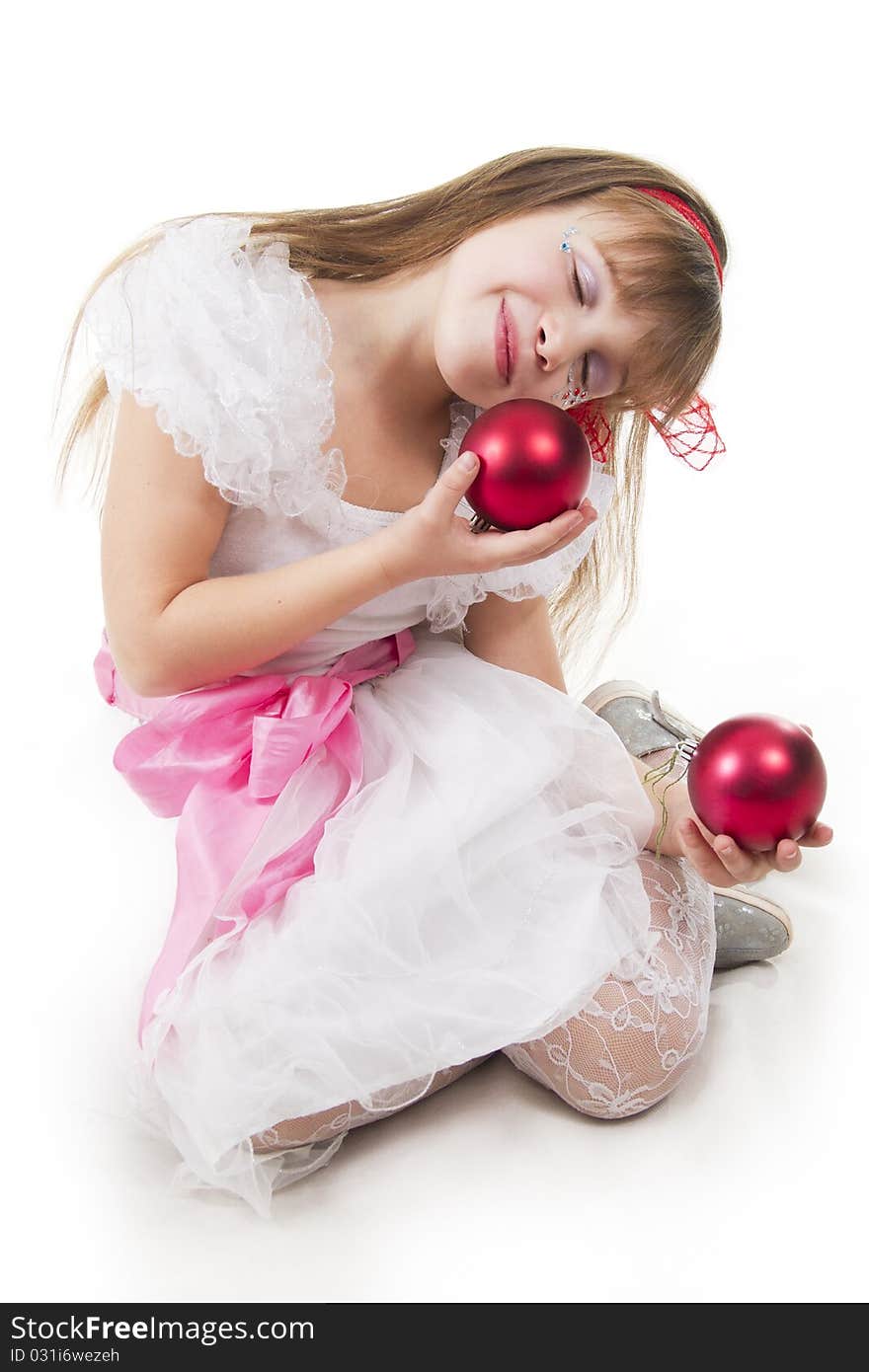 Small cheerful girl plays with Christmas red ball