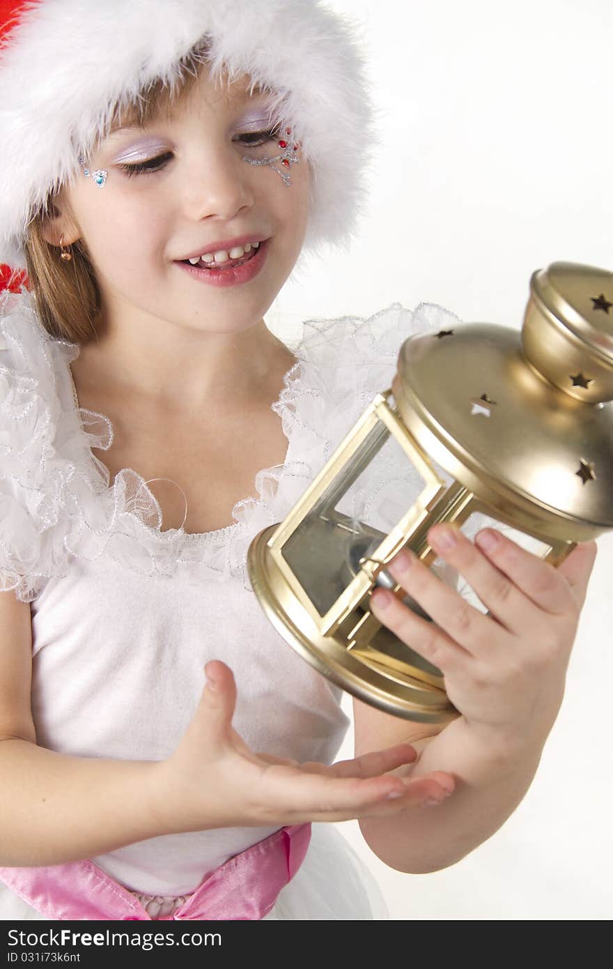 Little girl Santa holds a Christmas lantern being surprised. Little girl Santa holds a Christmas lantern being surprised