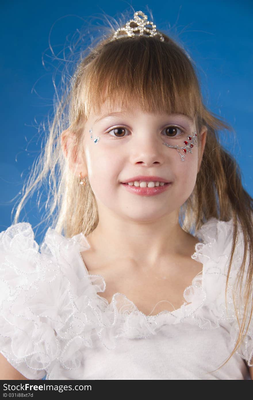 The girl the princess in a white dress opposite to a blue background. The girl the princess in a white dress opposite to a blue background