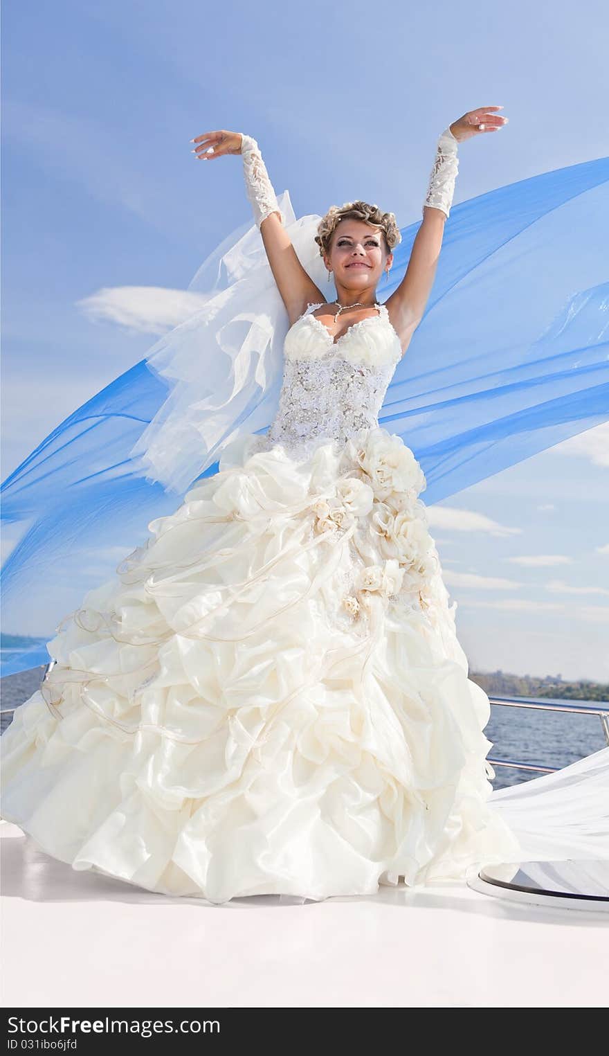 Happy bride on the yacht,  the blue sky