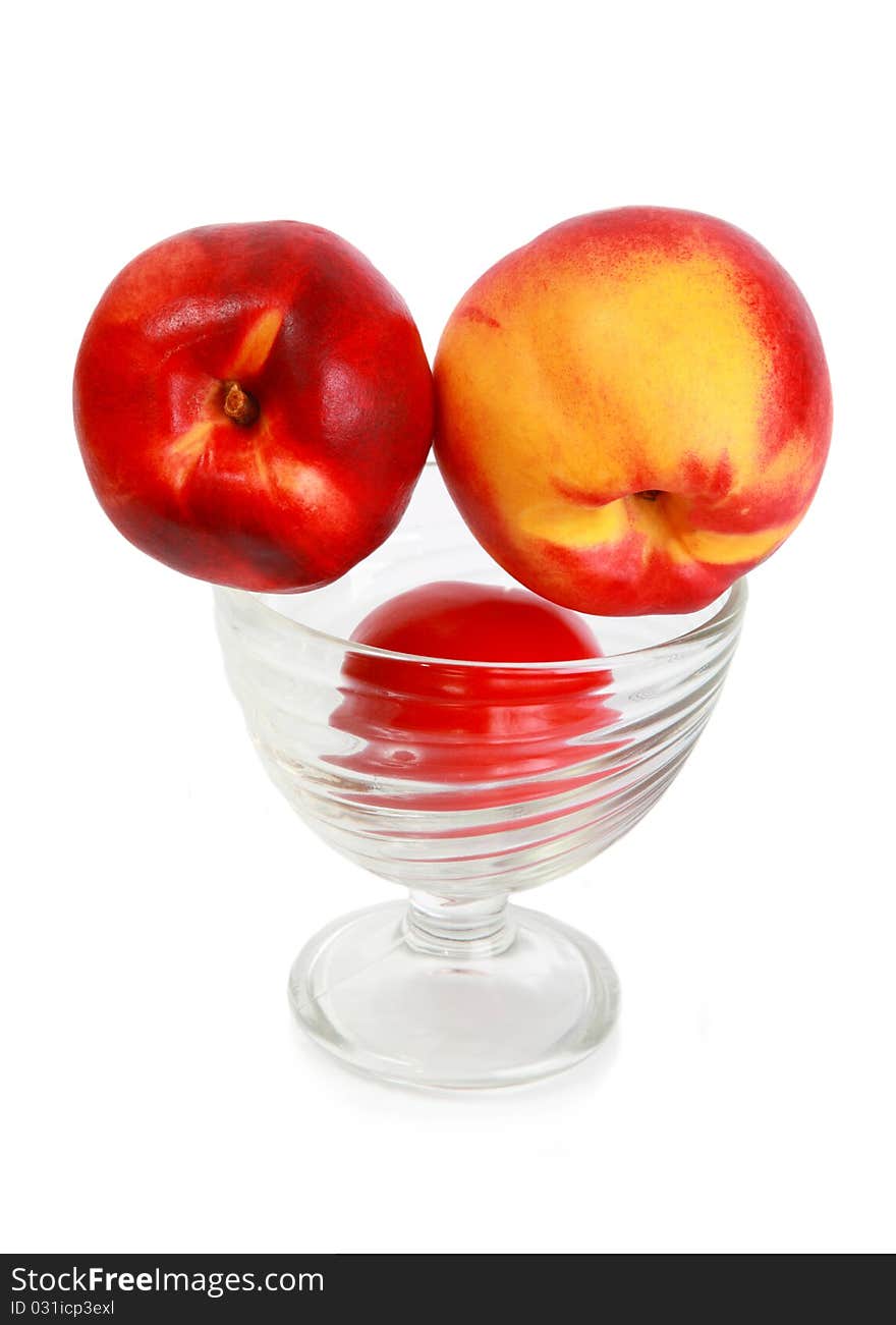 Ripe fresh tasty appetizing nectarine in a glass bowl isolated on a white background. Ripe fresh tasty appetizing nectarine in a glass bowl isolated on a white background