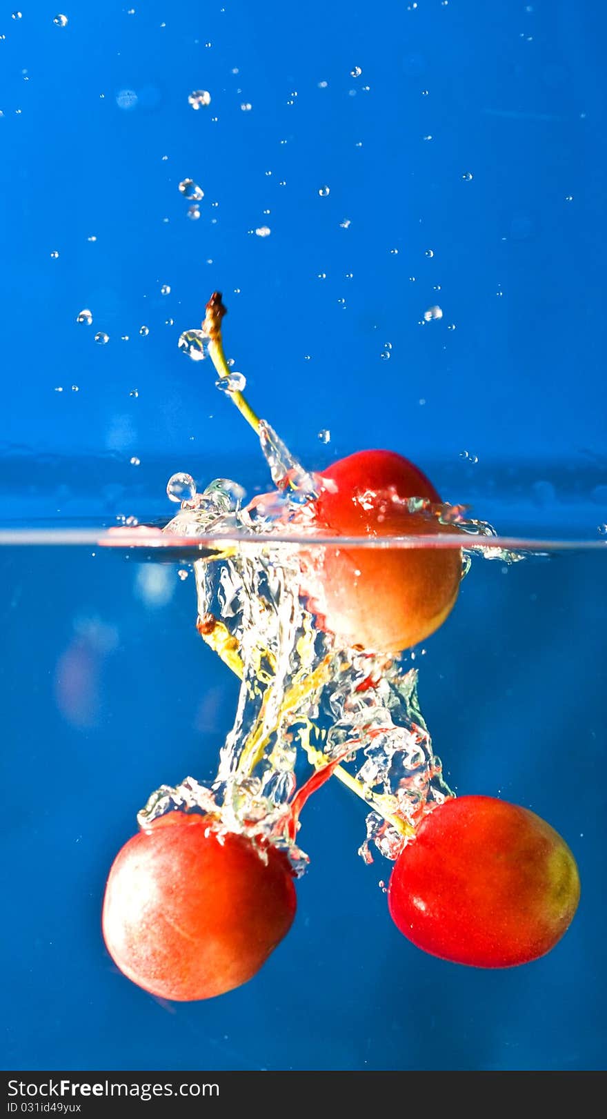 Cherry splashing in blue background