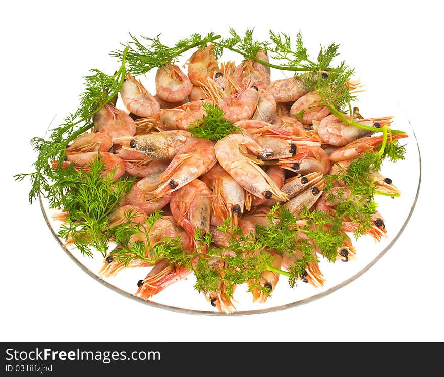 Boiled shrimps with the roe and the dill on the glass plate