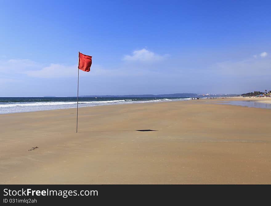 Red flag in a solitaire beach. Red flag in a solitaire beach