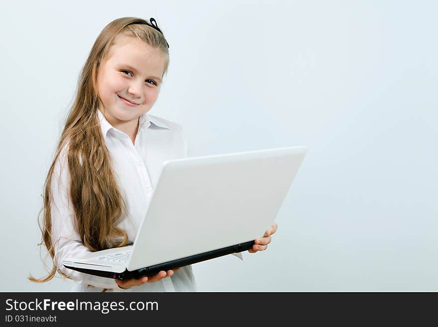 Funny cute girl with a laptop indoors. Funny cute girl with a laptop indoors