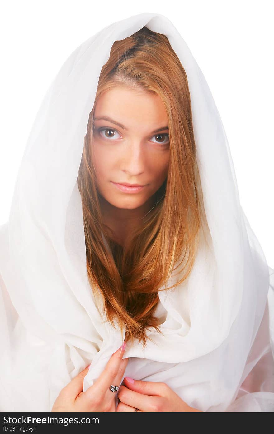 A young girl with blond hair that looked like an angel, dressed in white, white hood on his head, mysteriously looking into the frame