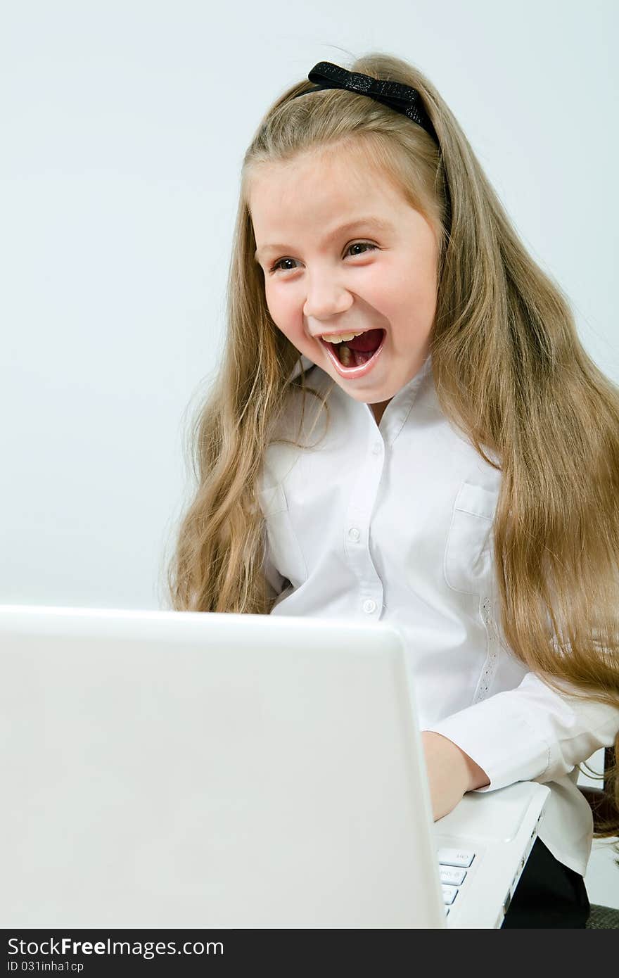 Funny cute girl with a laptop indoors. Funny cute girl with a laptop indoors