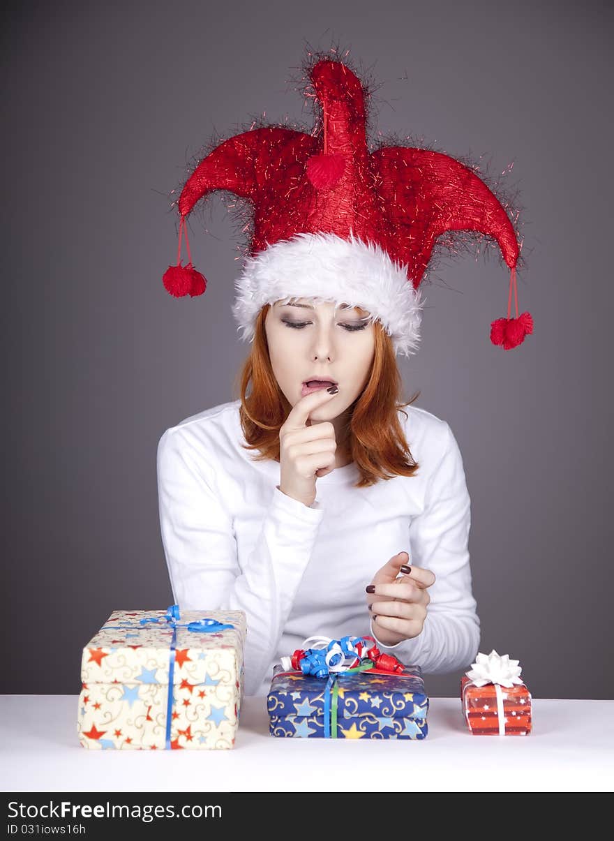 Funny red-haired girl in christmas cap