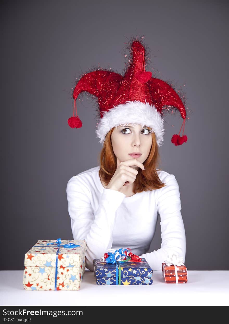 Funny red-haired girl in christmas cap