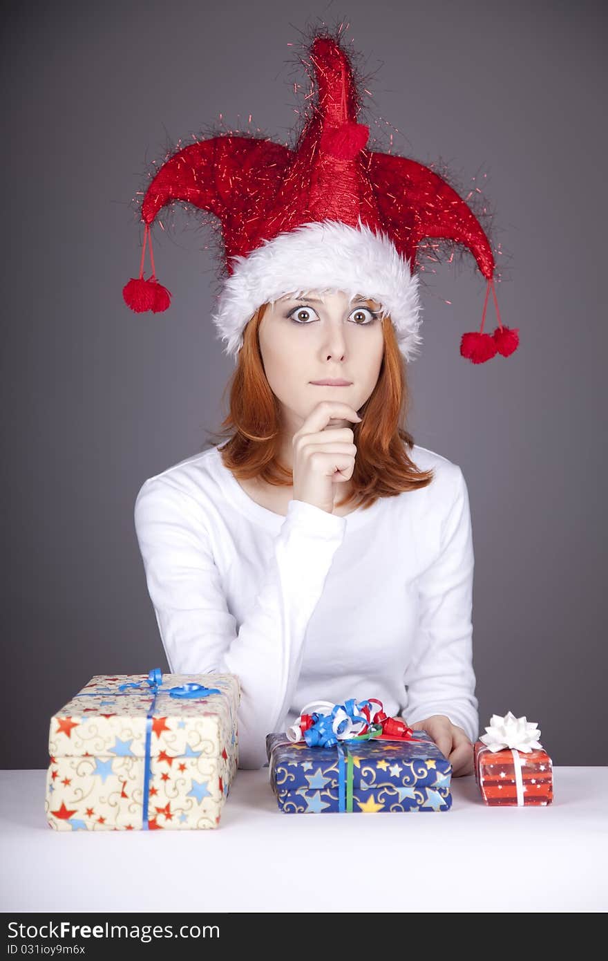 Funny red-haired girl in christmas cap