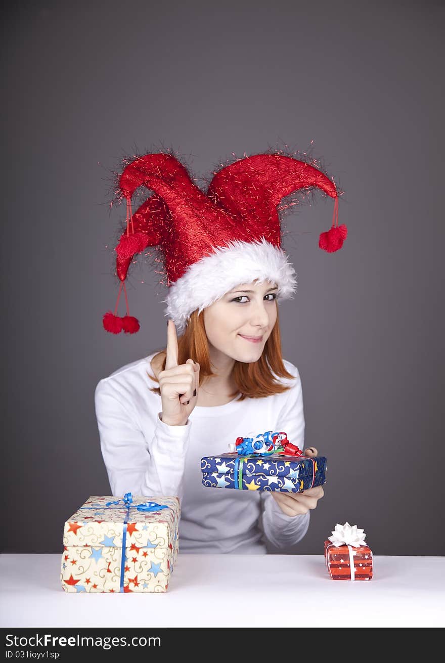 Funny red-haired girl in christmas cap