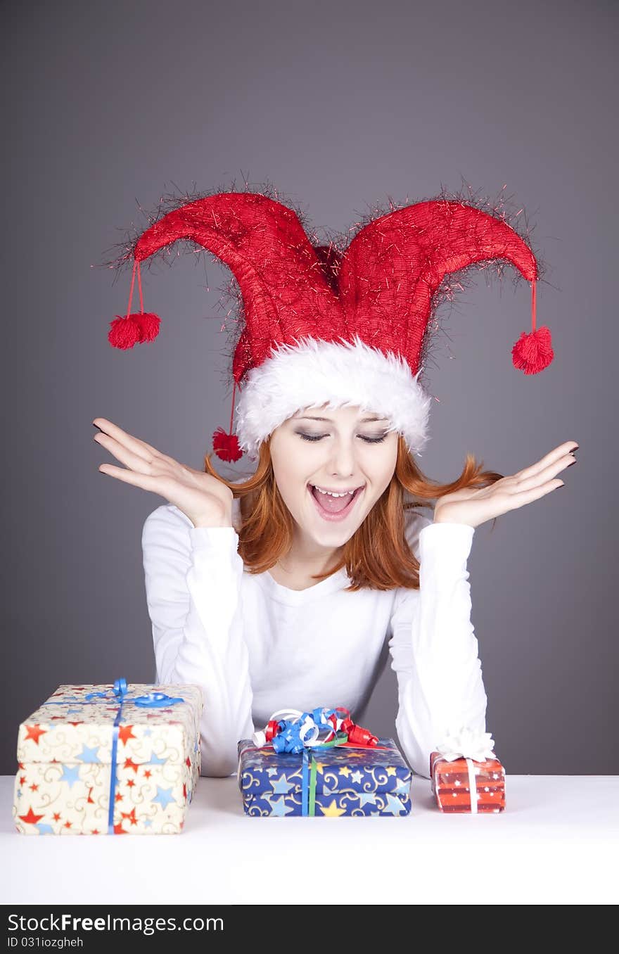 Funny red-haired girl in christmas cap