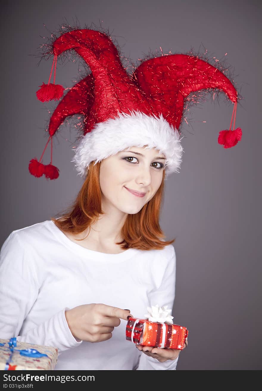 Funny red-haired girl in christmas cap