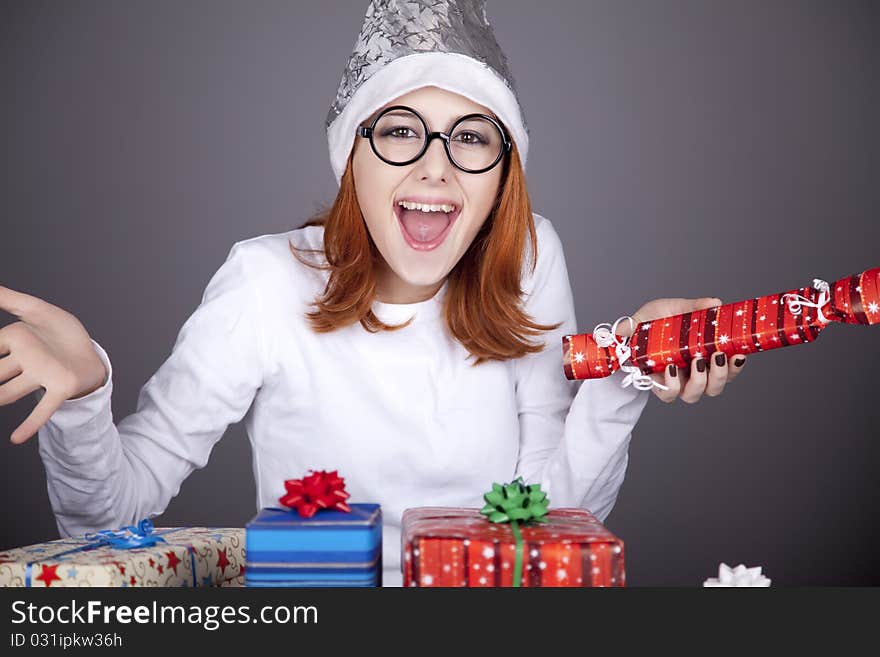 Surprised red-haired girl in christmas cap