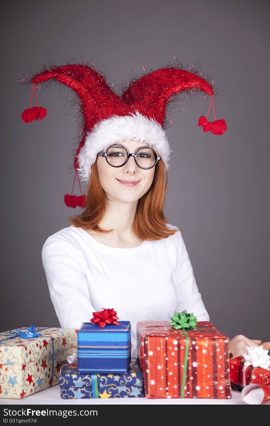 Surprised red-haired girl in christmas cap