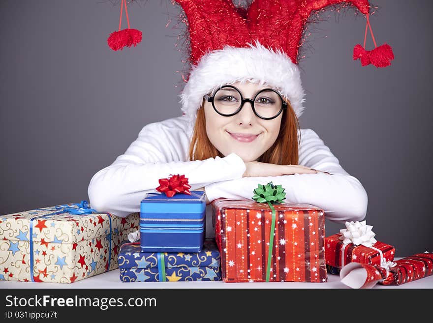 Surprised red-haired girl in christmas cap