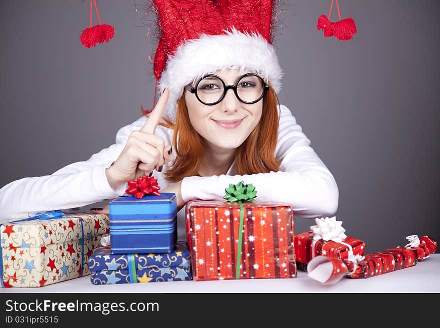 Surprised red-haired girl in christmas cap