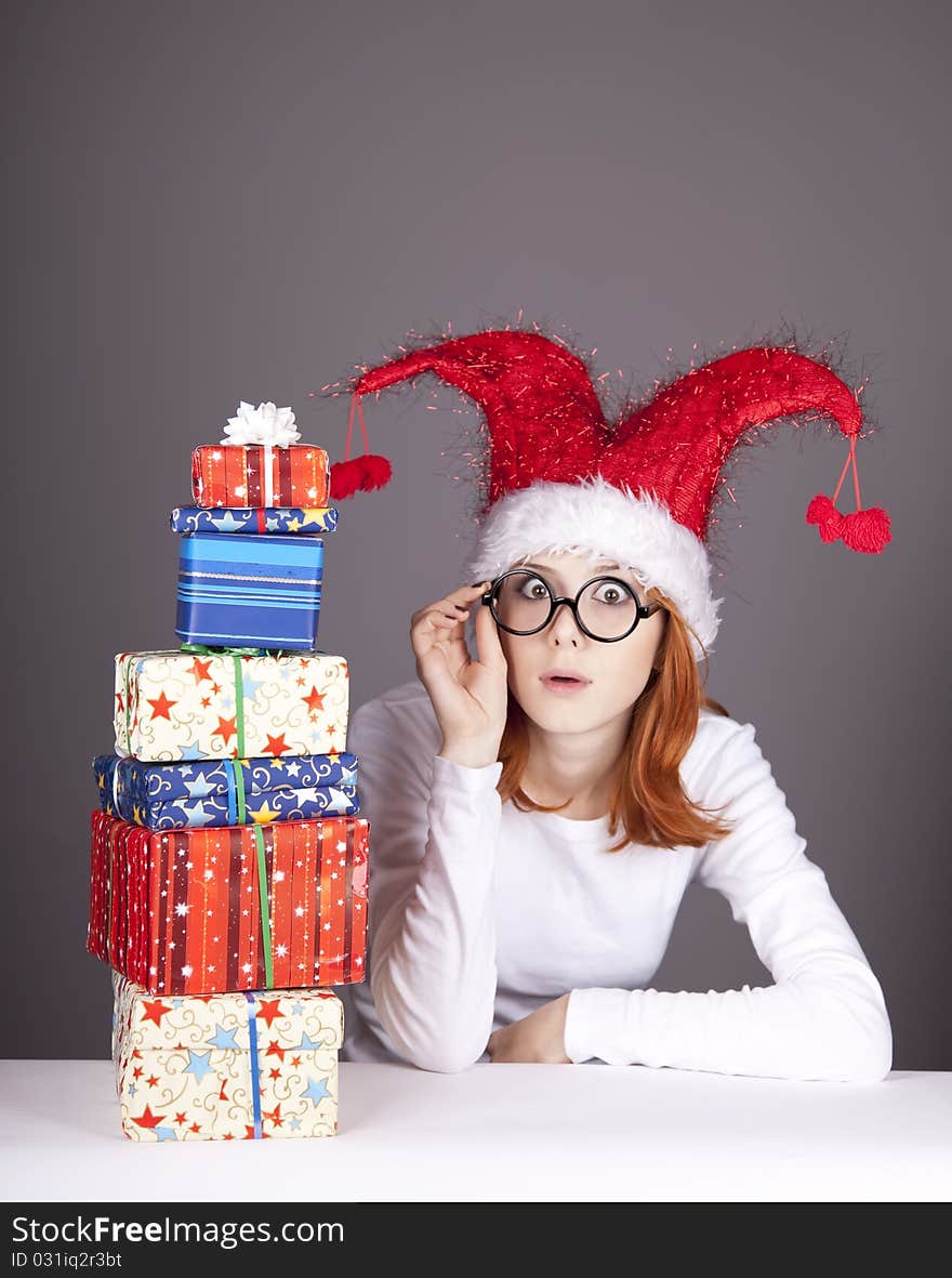 Surprised red-haired girl in christmas cap