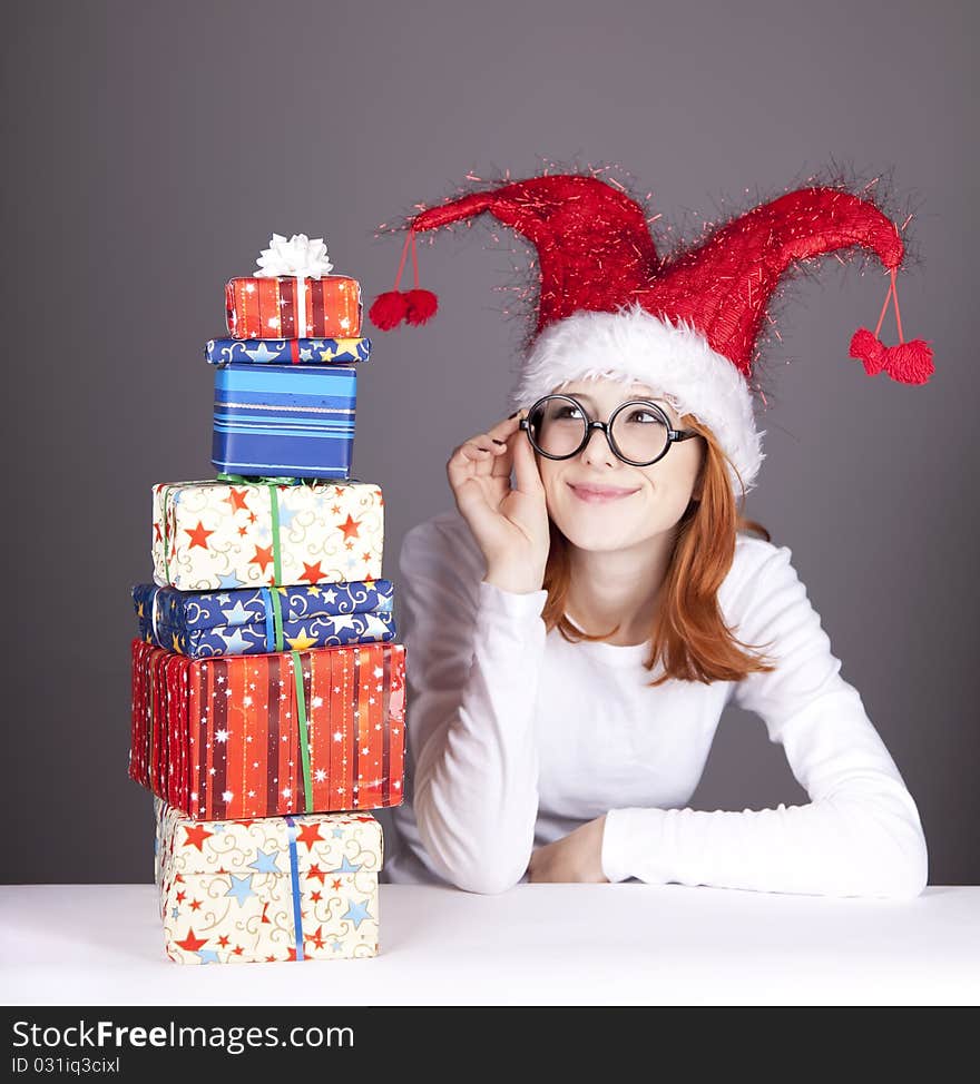 Surprised red-haired girl in christmas cap