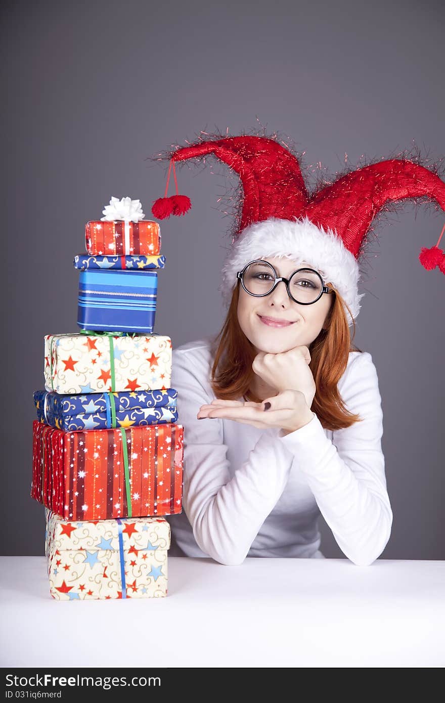 Surprised red-haired girl in christmas cap