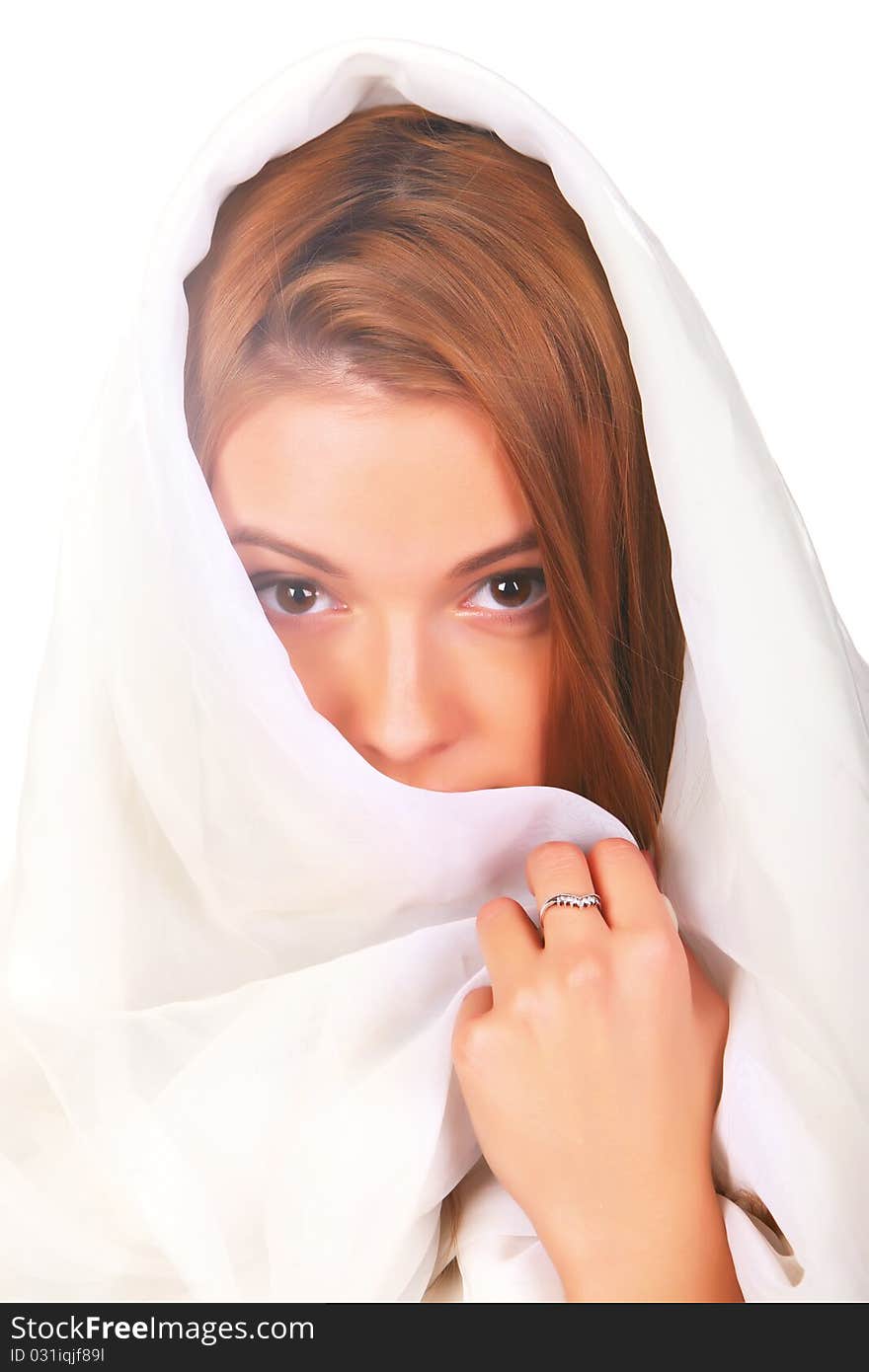 A young girl with blond hair that looked like an angel, dressed in white, white hood on his head, mysteriously looking into the frame