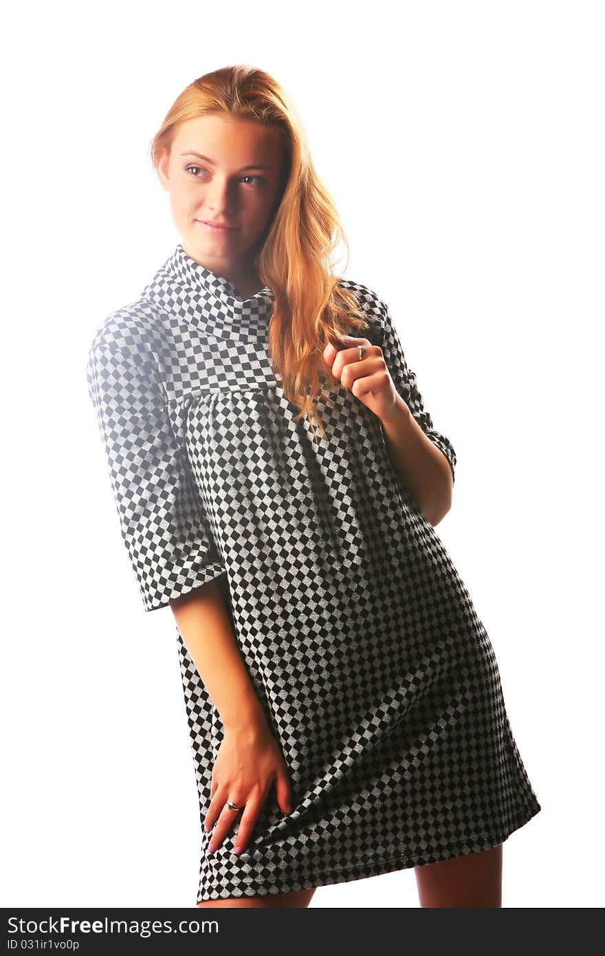 The Blonde Girl In A Checkered Dress On A White