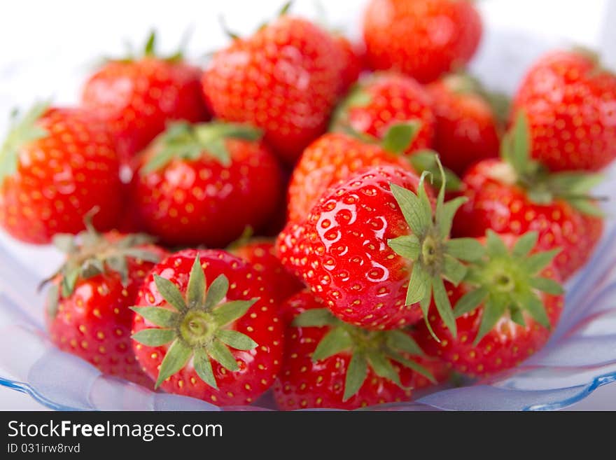 A bowl of ripe and red strawberries ready to be eaten.