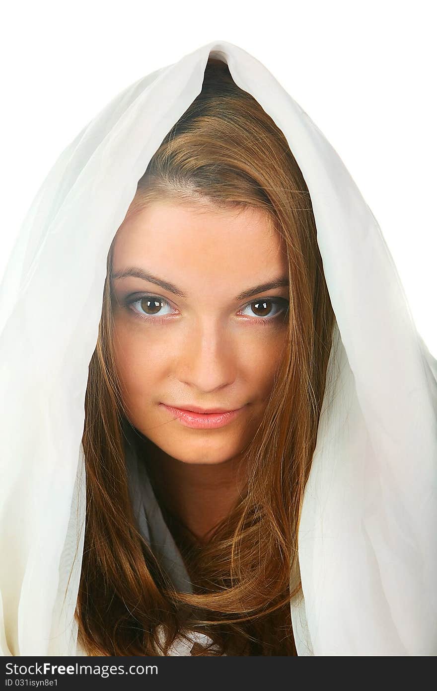 A young girl with blond hair that looked like an angel, dressed in white, white hood on his head, mysteriously looking into the camera