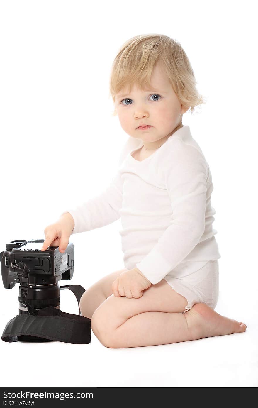 Baby dressed in white with black camera isolated on white. Baby sit looking in the squatting position. Baby dressed in white with black camera isolated on white. Baby sit looking in the squatting position