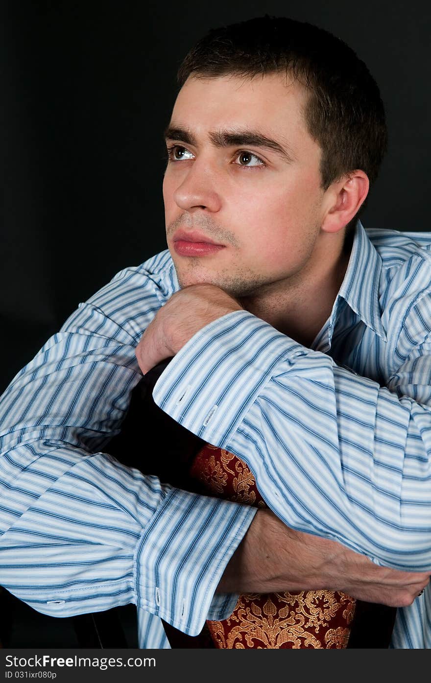 Young man sitting on a chair