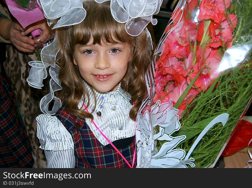 Portrait of the smiling girl of the schoolgirl on September, 1st with a bunch of flowers. Portrait of the smiling girl of the schoolgirl on September, 1st with a bunch of flowers