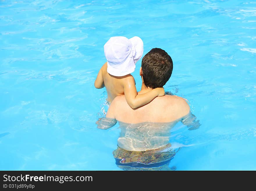 Father And Daughter Swim In The Pool