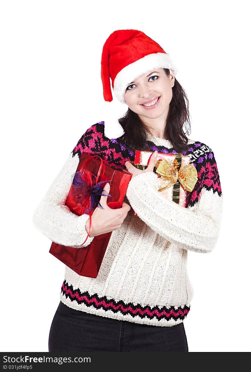 Cheerful and smiling woman in red Santa hat is keeping boxes with gifts. Cheerful and smiling woman in red Santa hat is keeping boxes with gifts