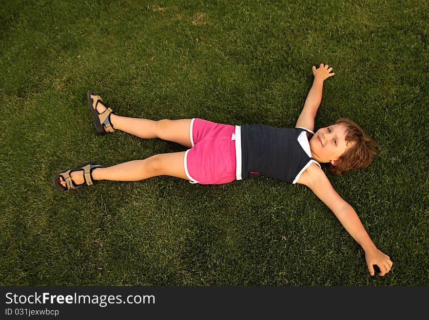 The girl lies on a green pitch. The image was taken in summer 2010. The girl lies on a green pitch. The image was taken in summer 2010