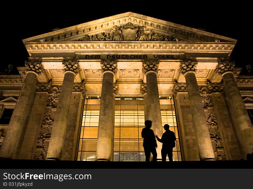 Two guys talking in front of German parliament called Reichstag. Two guys talking in front of German parliament called Reichstag