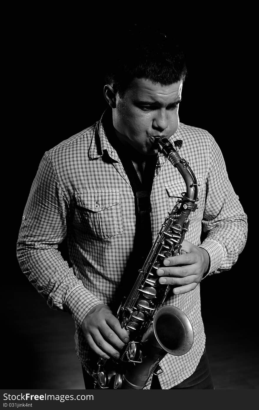 Young Handsome Man Playing Music On Saxophone