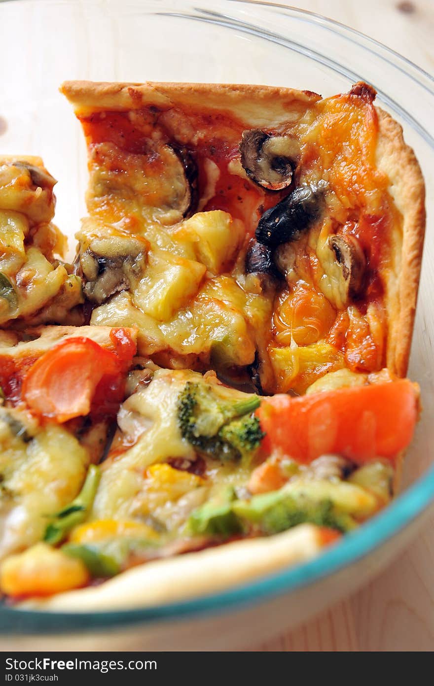 A slice of hot, fresh pizza being served in a bowl. A slice of hot, fresh pizza being served in a bowl.