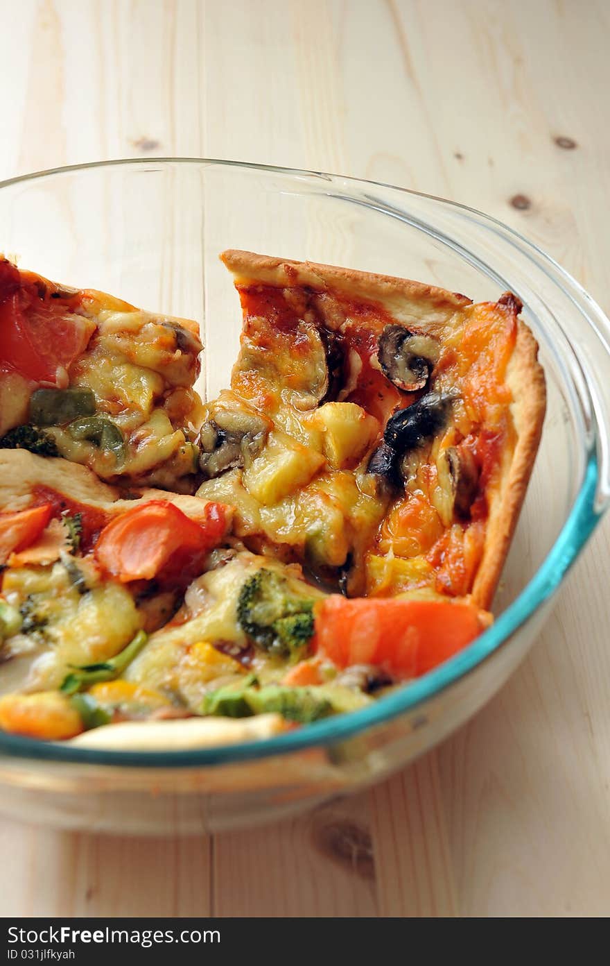 A slice of hot, fresh pizza being served in a bowl. A slice of hot, fresh pizza being served in a bowl.