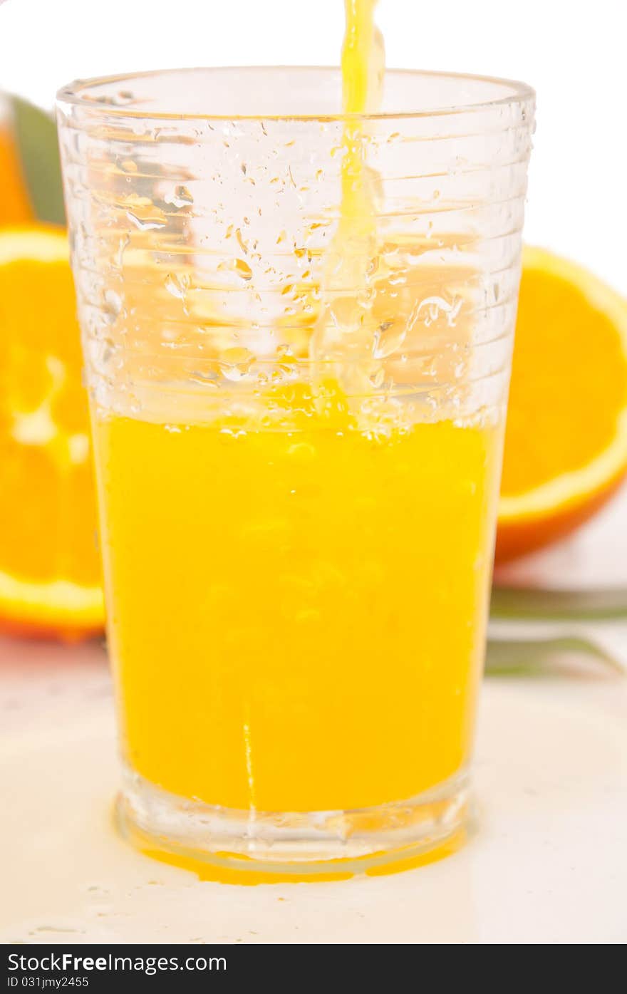 Orange juice and freshly squeezed orange