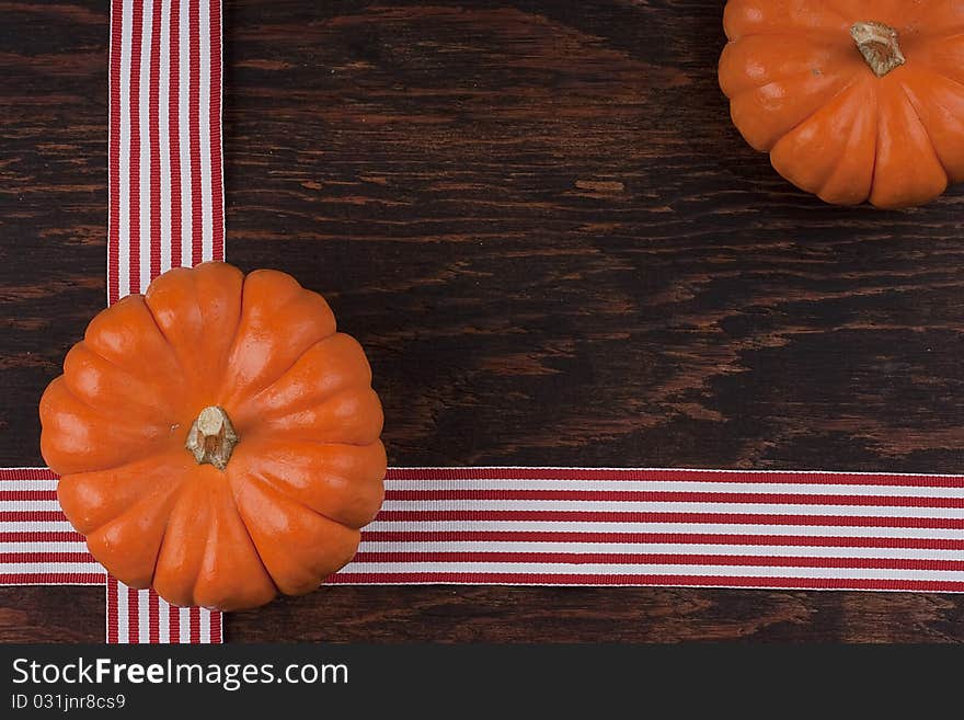 Small orange pumpkins symbolising autumn holidays and used in decorative works.