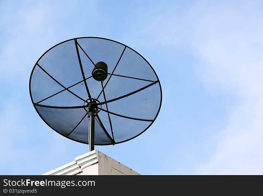 Black satellite dish, blue sky