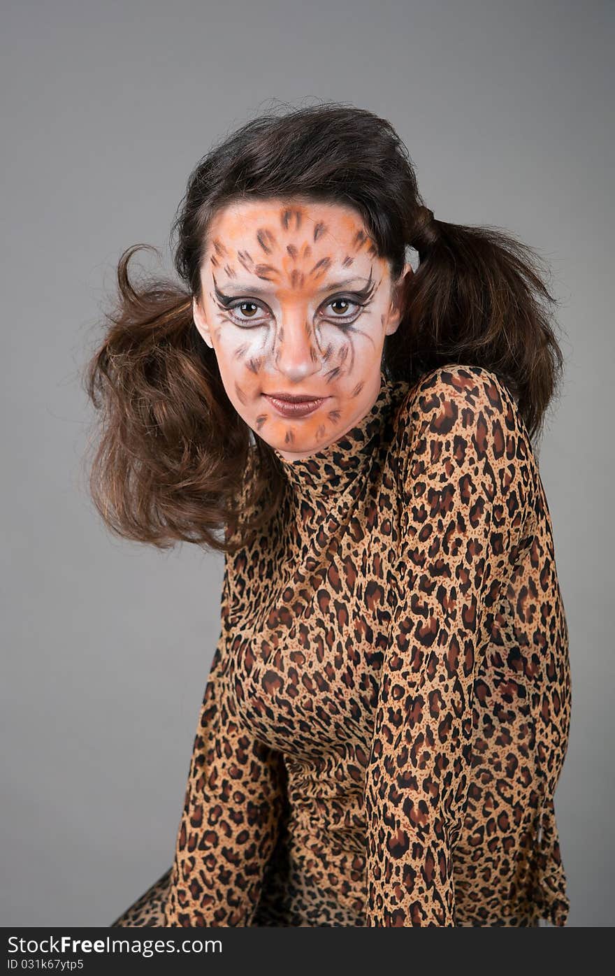 Portrait of girl with leopard's face-art in the studio